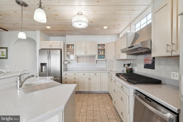 kitchen with white cabinetry, appliances with stainless steel finishes, decorative light fixtures, wood ceiling, and sink