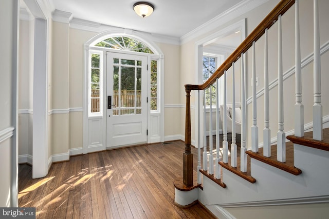 entrance foyer with wood-type flooring and ornamental molding