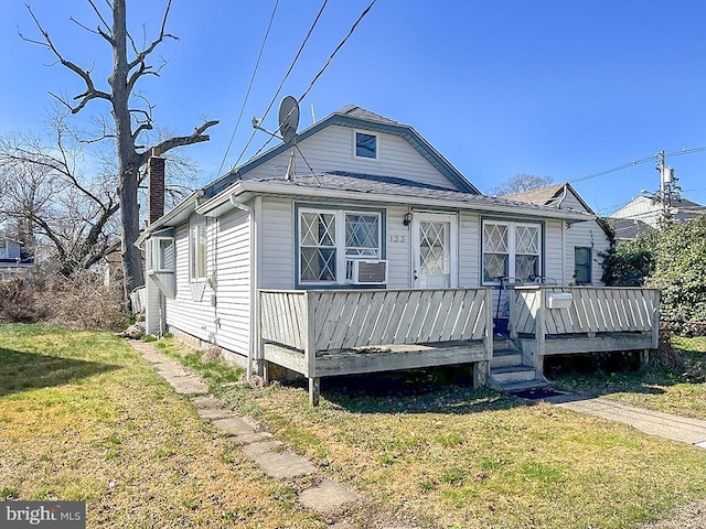 bungalow-style house with a front yard and a deck