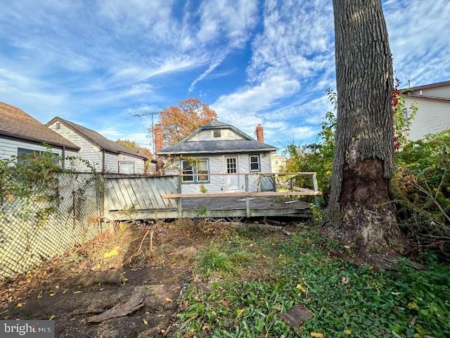 123 Forest Ave, Keansburg, NJ 07734 - rear view of house featuring fence, a chimney, and a wooden deck