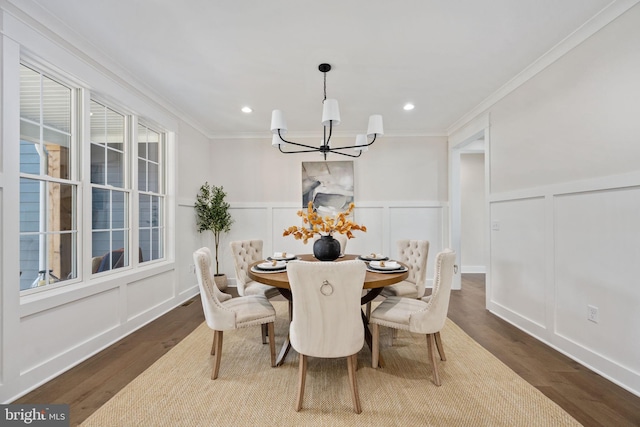 dining area with dark wood-type flooring, a healthy amount of sunlight, a notable chandelier, and ornamental molding