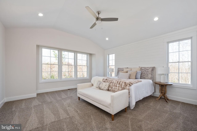 carpeted bedroom with ceiling fan, multiple windows, and vaulted ceiling