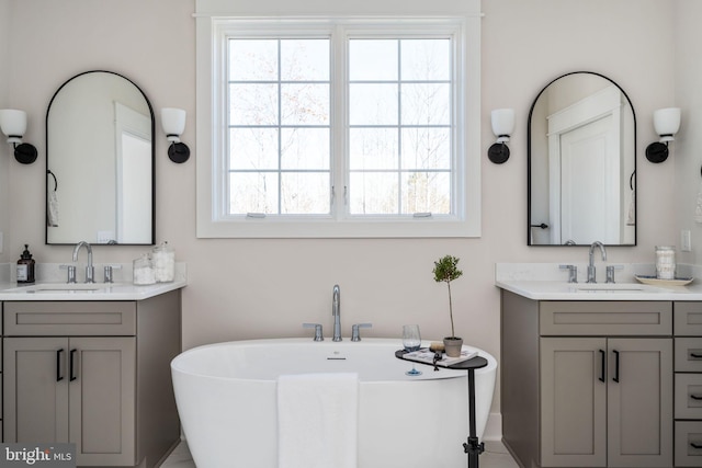 bathroom with a bath and vanity