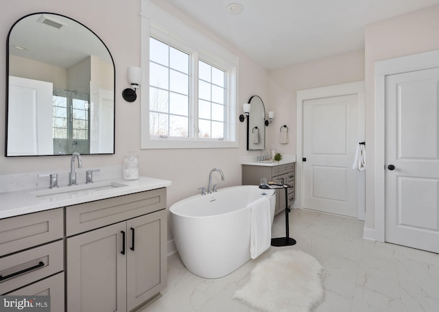 bathroom featuring vanity and a tub