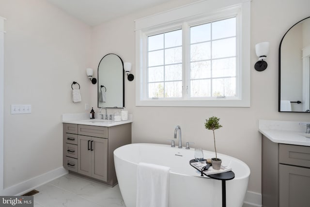 bathroom featuring a tub and vanity