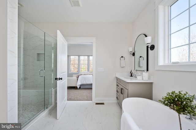 bathroom featuring a shower with shower door and vanity