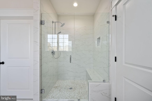 bathroom featuring a shower with shower door