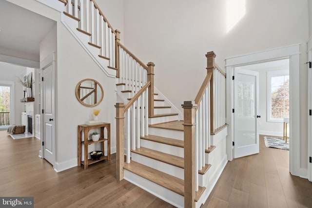 stairs with hardwood / wood-style flooring