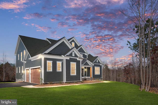 view of front of property featuring a lawn and a garage