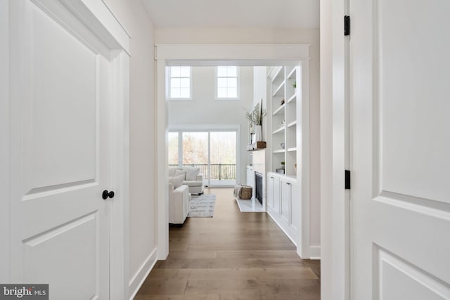 hallway with hardwood / wood-style flooring