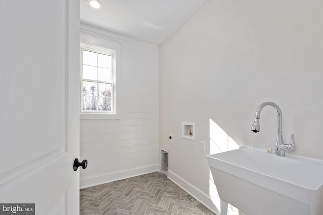 laundry area with parquet floors, washer hookup, sink, and electric dryer hookup