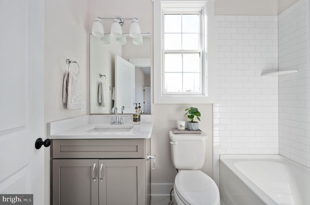 full bathroom with vanity, tiled shower / bath combo, and toilet