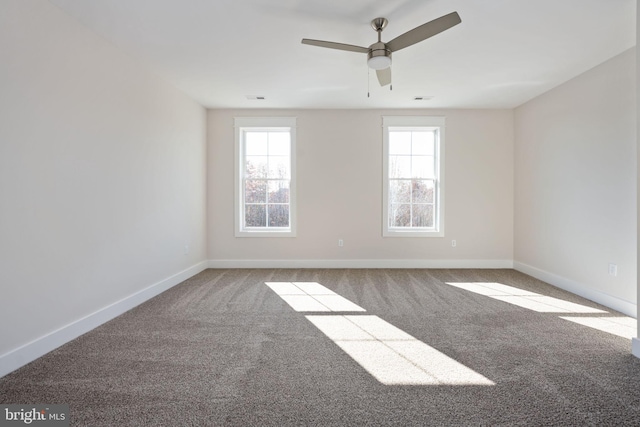 carpeted empty room with ceiling fan and a healthy amount of sunlight