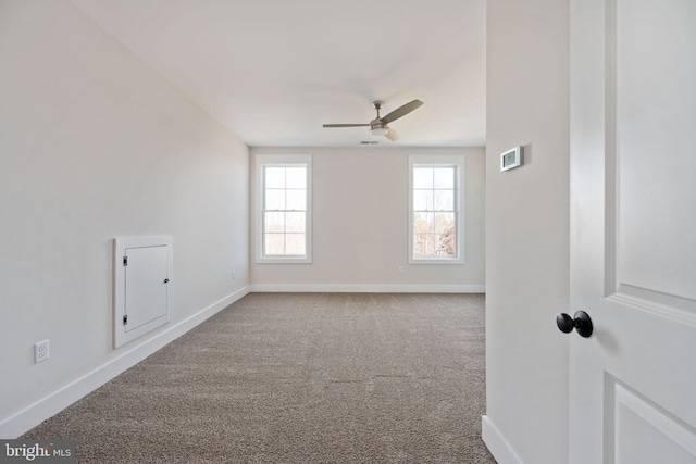 carpeted spare room with ceiling fan