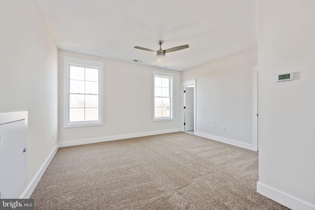 empty room featuring ceiling fan and carpet floors