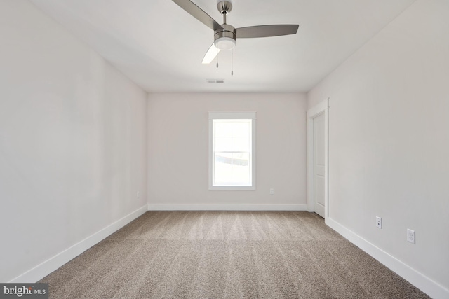 carpeted spare room featuring ceiling fan