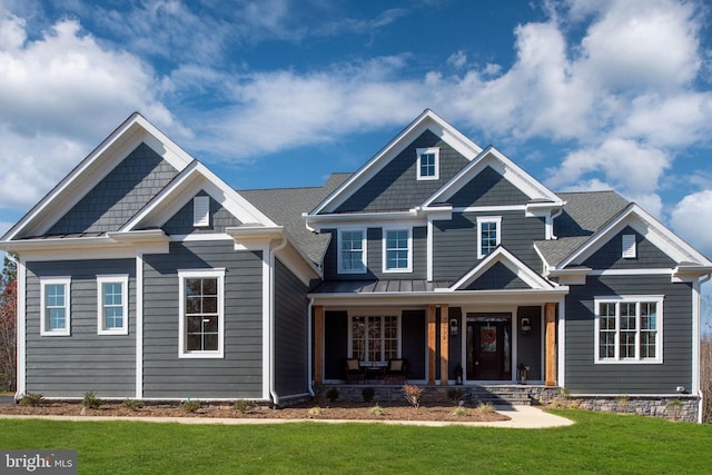 craftsman-style home with a front lawn and covered porch