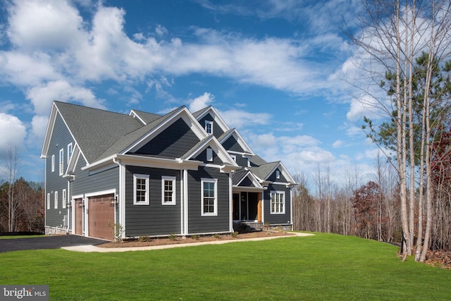 craftsman house featuring a front lawn and a garage