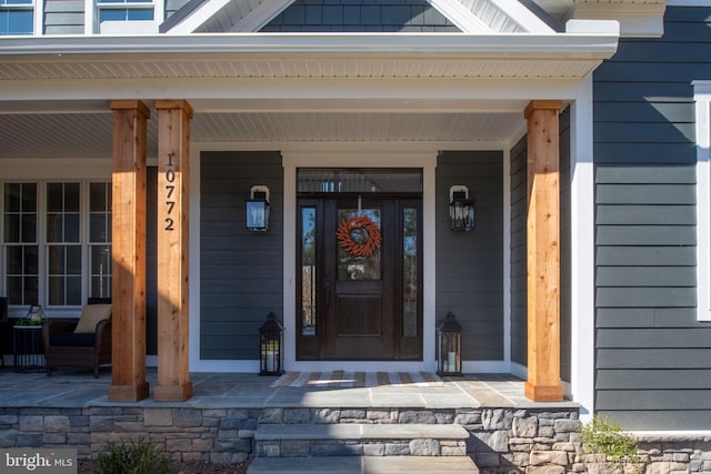 doorway to property featuring covered porch