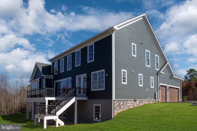 view of property exterior featuring a garage, a wooden deck, and a yard