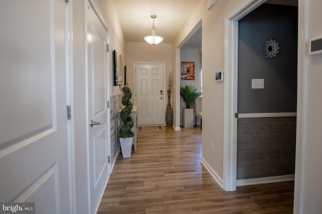 corridor with light hardwood / wood-style flooring