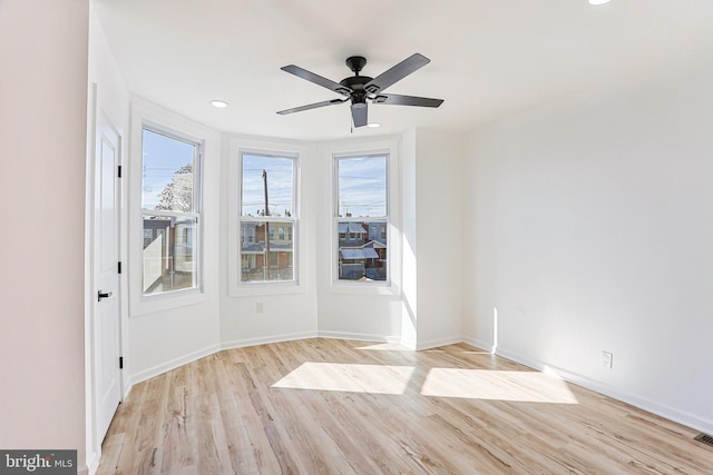 spare room featuring light wood-type flooring and ceiling fan