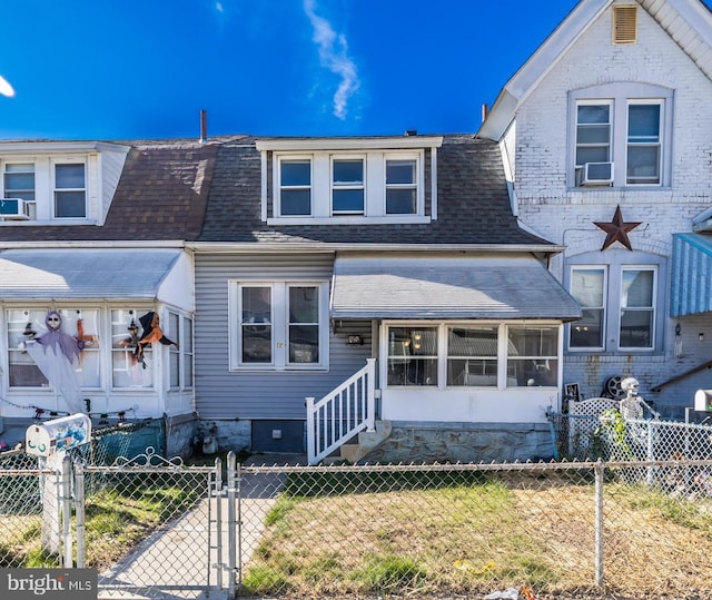 view of front of home with cooling unit and a sunroom