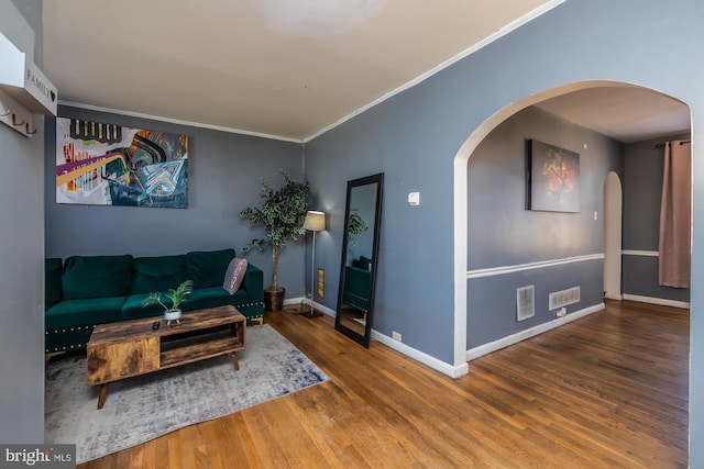 living room featuring ornamental molding and hardwood / wood-style flooring