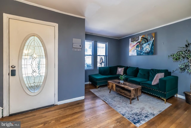 foyer entrance featuring crown molding and hardwood / wood-style floors