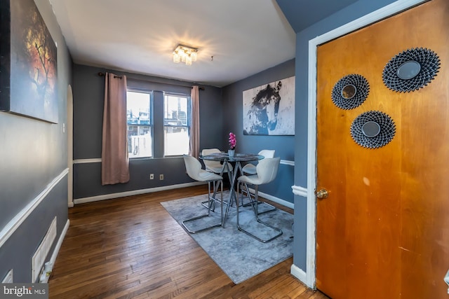 dining area with dark wood-type flooring