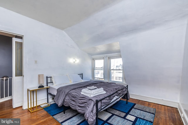 bedroom with hardwood / wood-style flooring and vaulted ceiling