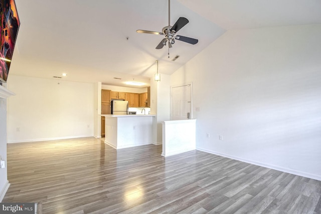 unfurnished living room with high vaulted ceiling, hardwood / wood-style flooring, and ceiling fan