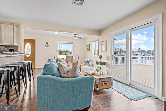 living room featuring wood-type flooring and ceiling fan