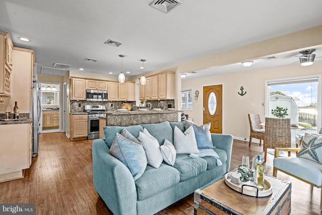 living room featuring ceiling fan and wood-type flooring