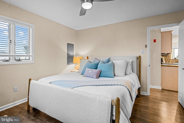 bedroom featuring electric panel, dark hardwood / wood-style floors, and ceiling fan