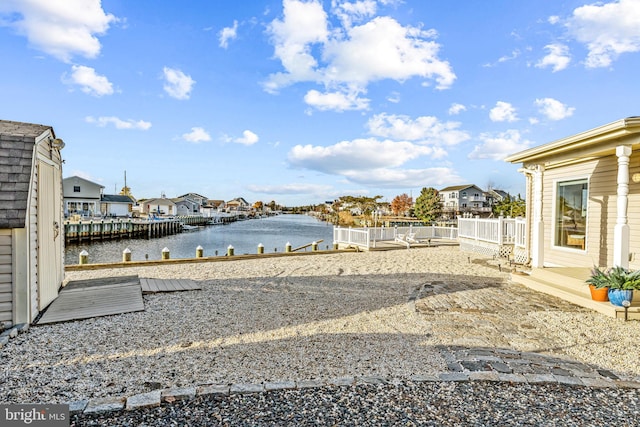 view of yard featuring a water view and a boat dock