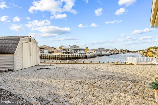 view of yard with a water view and a storage unit