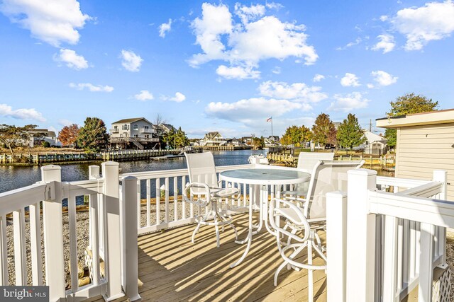 wooden terrace featuring a water view