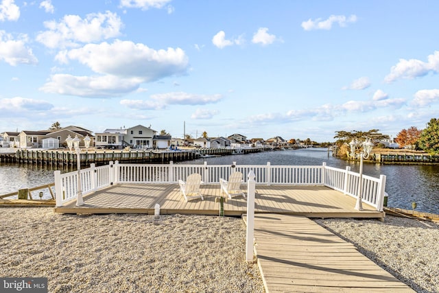 view of dock with a deck with water view