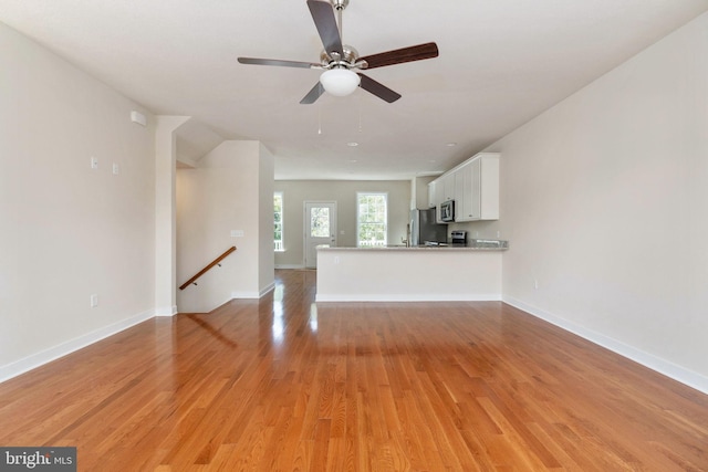 unfurnished living room featuring light hardwood / wood-style floors and ceiling fan