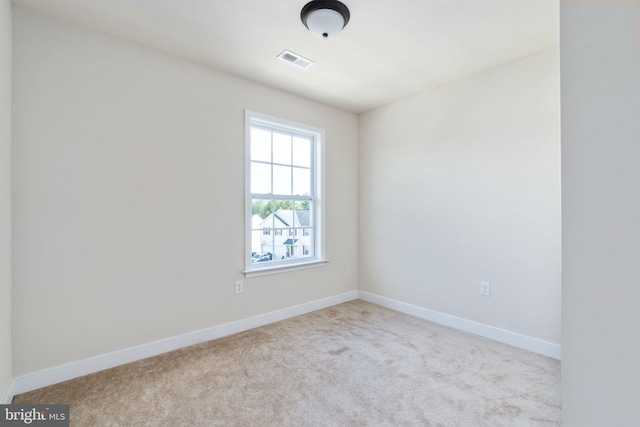 empty room with light colored carpet