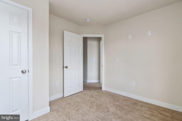 unfurnished bedroom with light colored carpet