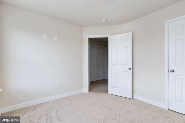 unfurnished bedroom featuring light colored carpet