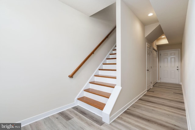 stairway with hardwood / wood-style flooring