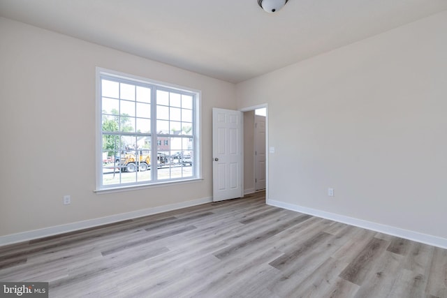 unfurnished room with light wood-type flooring