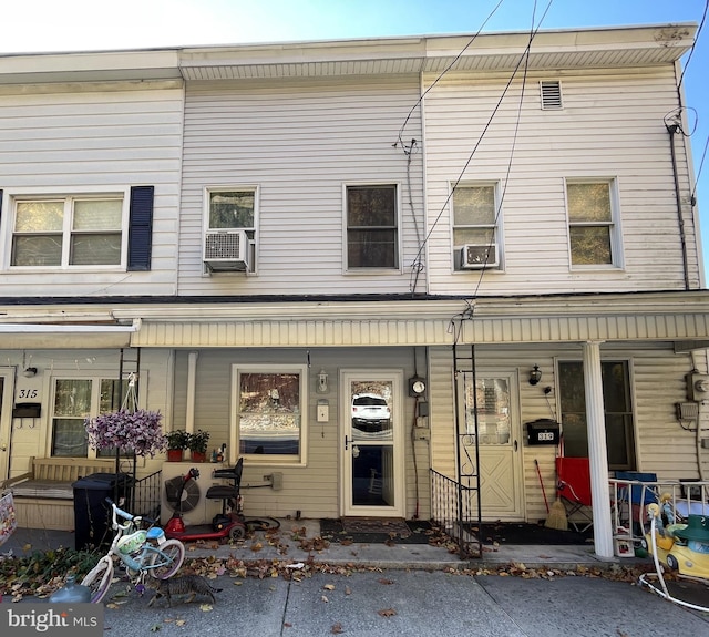 multi unit property featuring cooling unit and a porch