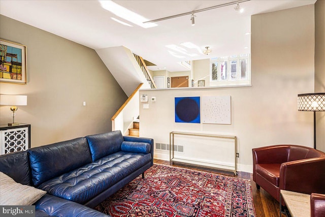 living room featuring hardwood / wood-style flooring and track lighting