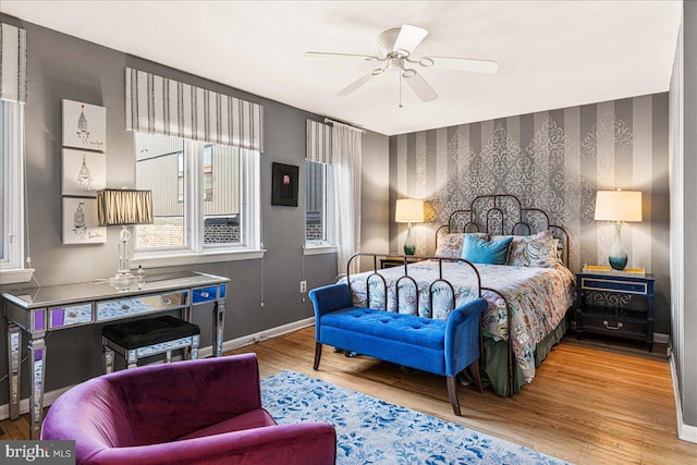 bedroom with light wood-type flooring and ceiling fan