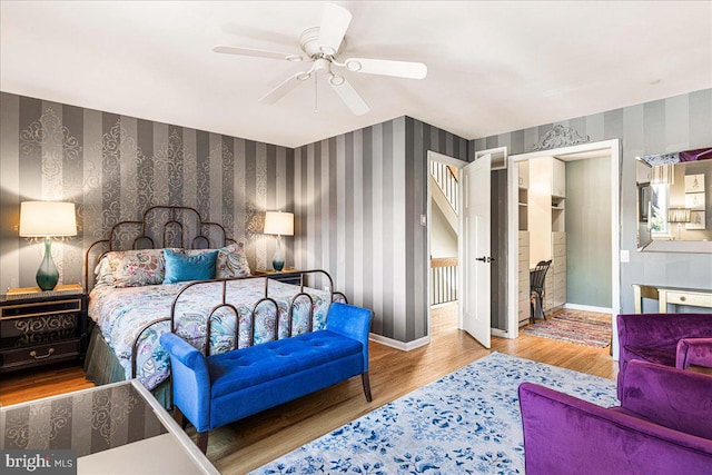 bedroom with ceiling fan and wood-type flooring