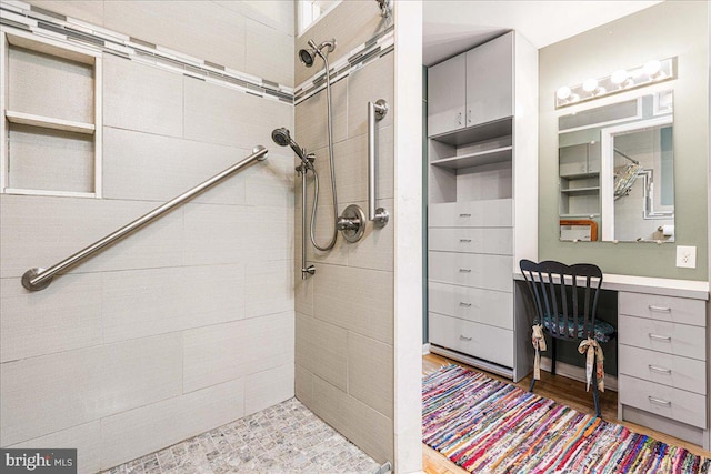 bathroom featuring tiled shower and hardwood / wood-style flooring